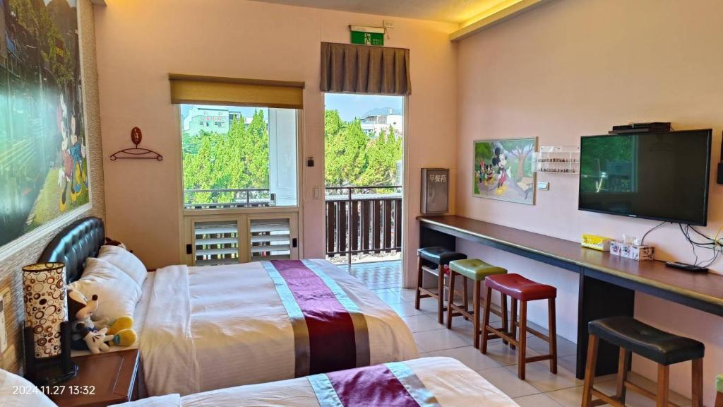 Postel nebo postele na pokoji v ubytování Jinge Guest House 集集金格民宿電動車充電站