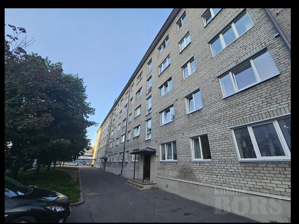 a large brick building with a door on the side of it at Private room at 2 km from Airport in Tallinn