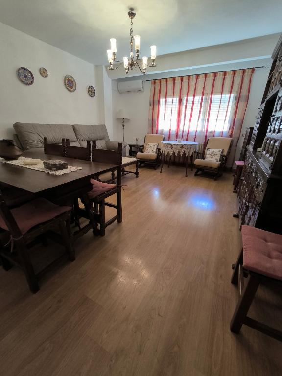 a living room with a table and chairs and a couch at Vivienda La Manola in Daimiel