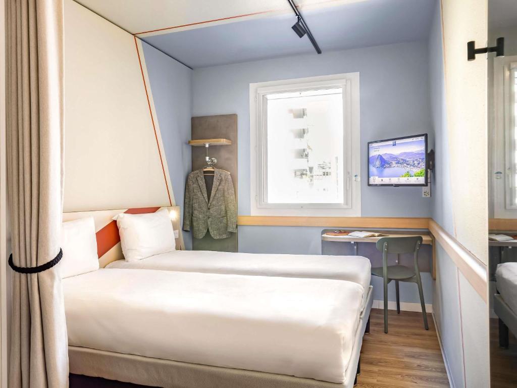 Postel nebo postele na pokoji v ubytování ibis budget Lugano Paradiso