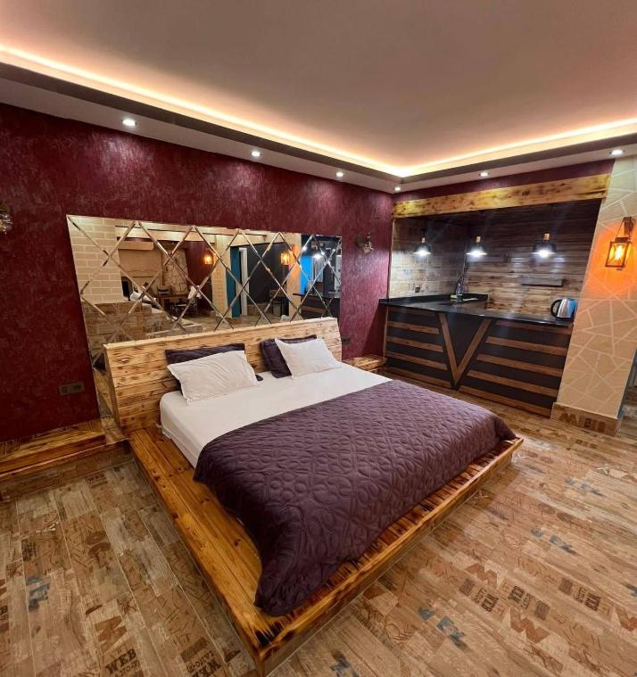 a bedroom with a large bed in a room at Loft Suit Apart Otel in İskenderun