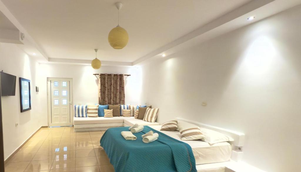 a living room with a couch and a blue table at Rida Village Ksamil Island in Ksamil