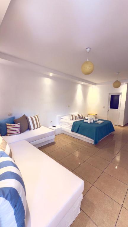 a large room with two beds and a couch at Rida Village Ksamil Island in Ksamil