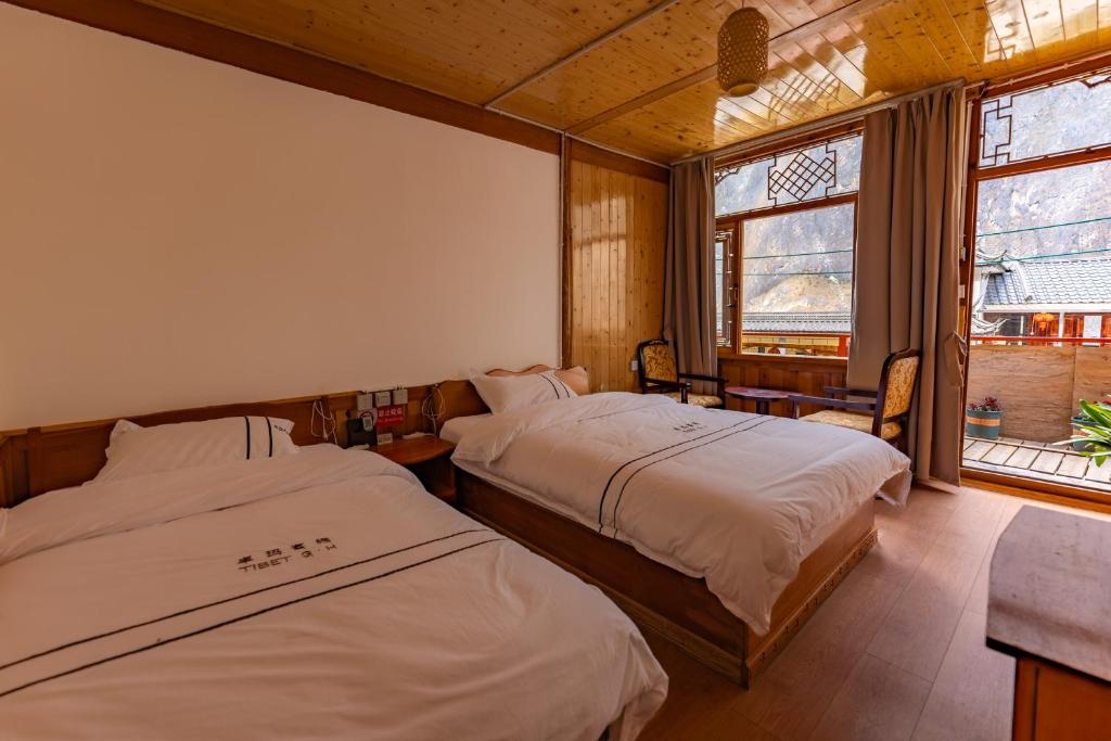 Postel nebo postele na pokoji v ubytování TIBET Guest house 虎跳峡卓玛客栈