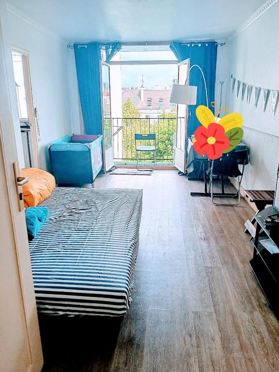 a bedroom with a bed with a flower on the floor at 3 chambre - La Chapelle in Paris