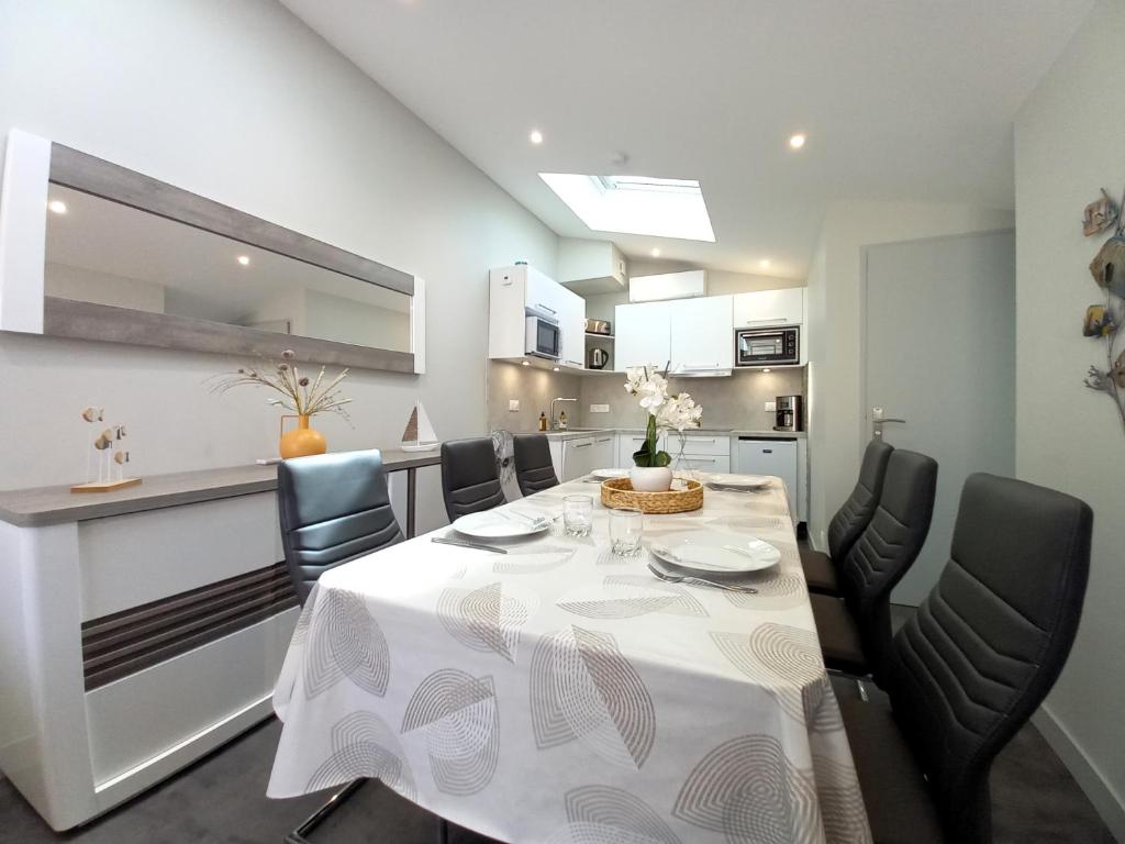 a dining room with a white table and chairs at Saint Georges de Didonne - TOUT CONFORT et TOUT A PIED - APPARTEMENT au TOP in Saint-Georges-de-Didonne