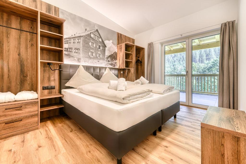 Postel nebo postele na pokoji v ubytování Brandnerhus by A-Appartments