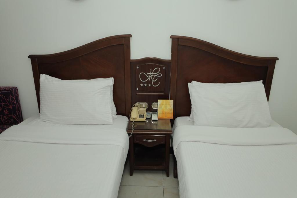 Postel nebo postele na pokoji v ubytování Happy City Hotel