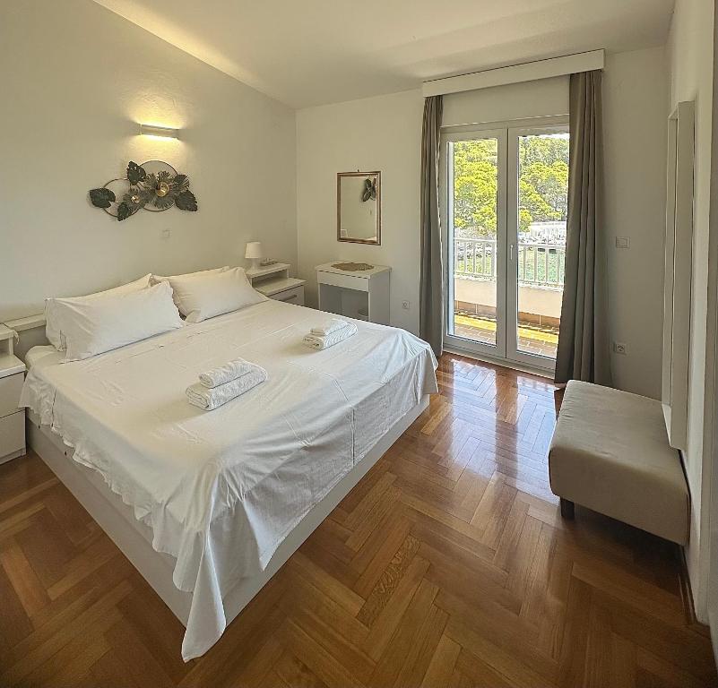 Łóżko lub łóżka w pokoju w obiekcie Villa Hosta Apartments