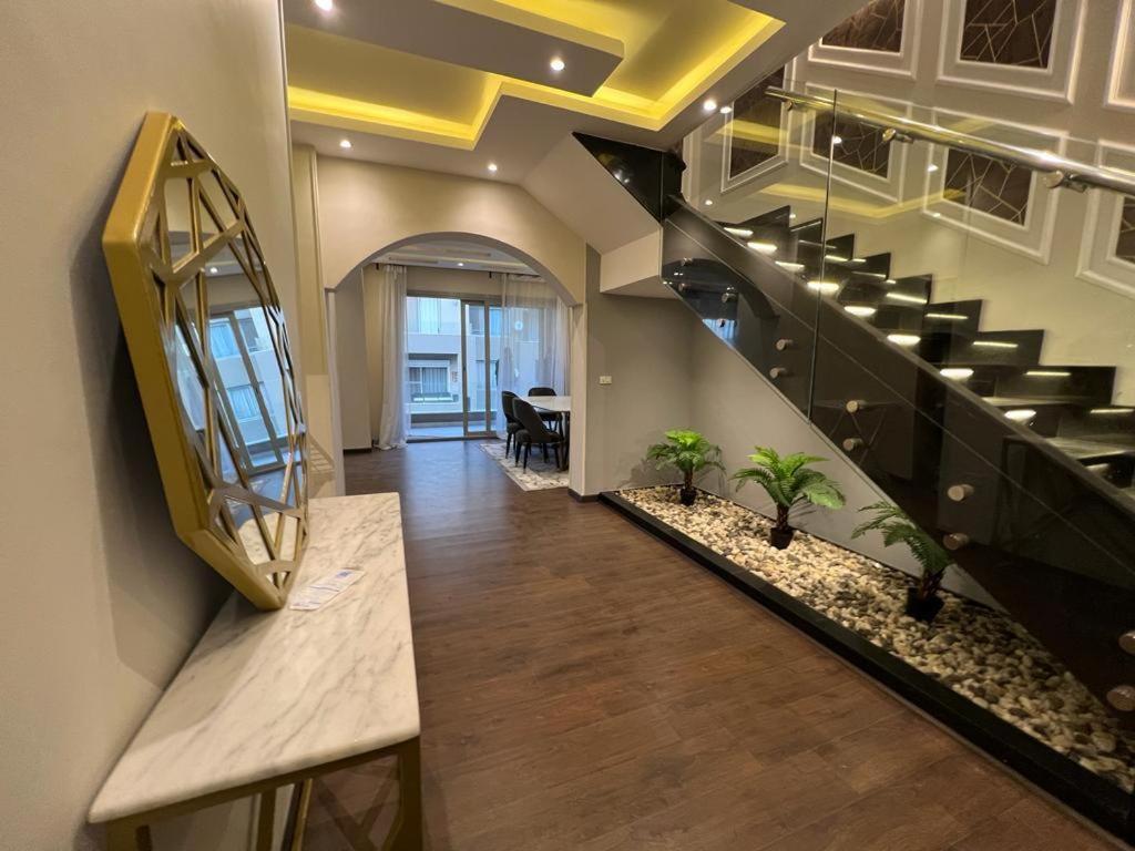 a hallway with a staircase with a bench and a mirror at Modern 3 bedroom Penthouse in Cairo
