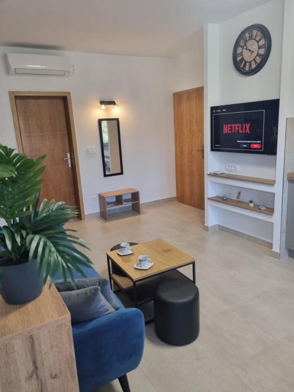 a living room with a blue couch and a table at Apartment Oliva in Krk