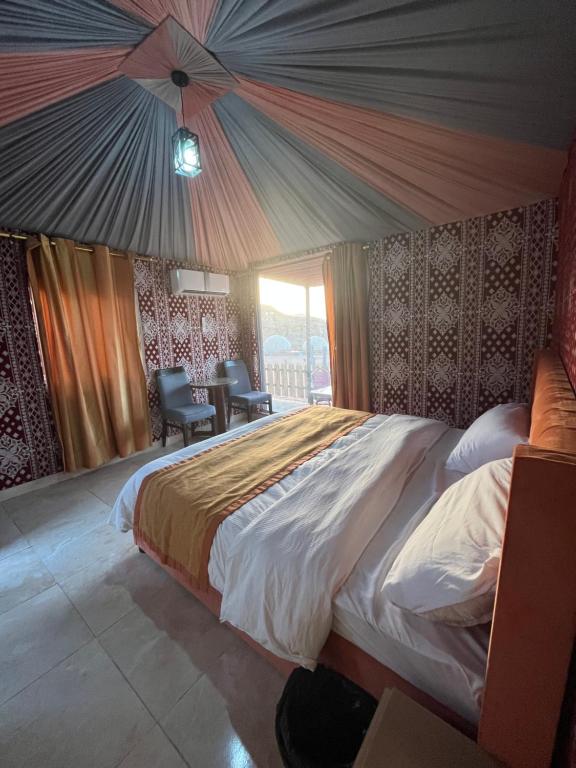 a bedroom with a large bed in a room at Al Raha Luxury Camp in Wadi Rum