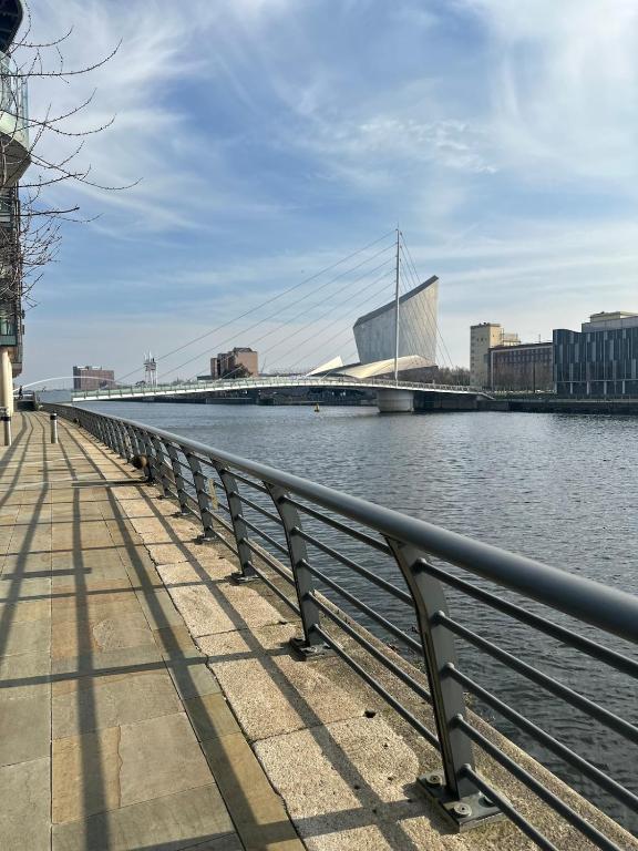 a bridge over the water next to a river at Apartment in MediaCity in Manchester