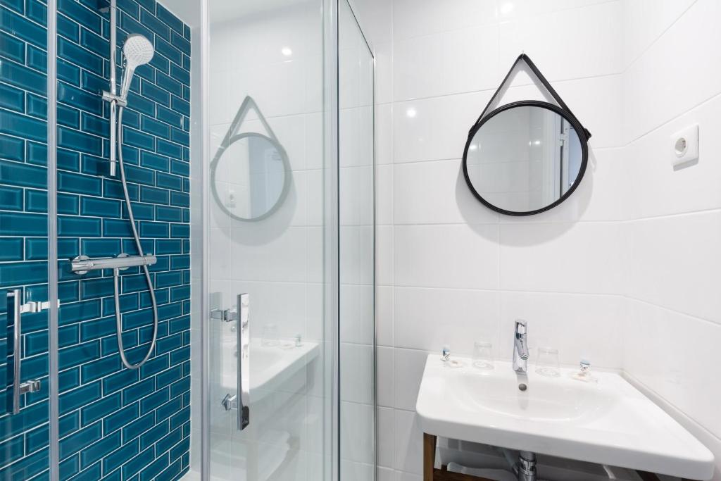 a bathroom with a sink and a shower and a mirror at Hotel Nap By HappyCulture in Nice