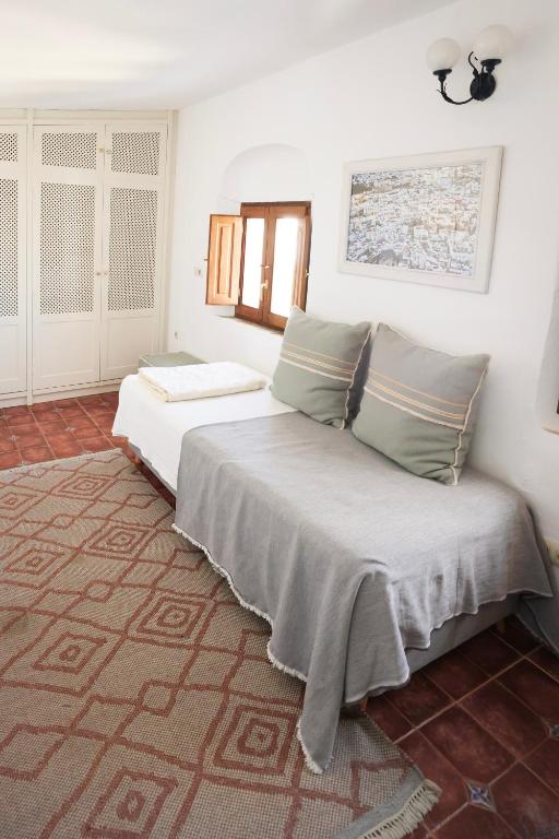 Postel nebo postele na pokoji v ubytování Casa Las Cuadras - Califa Casas Vejer