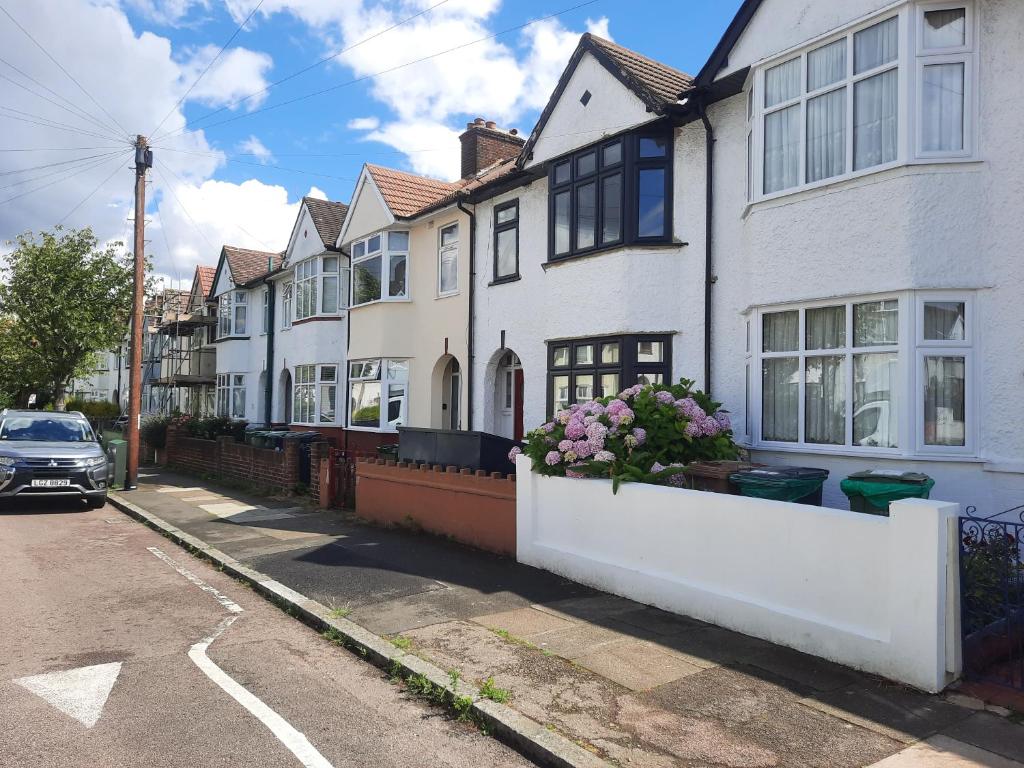 a row of white houses on a street at Alross Guest House in London