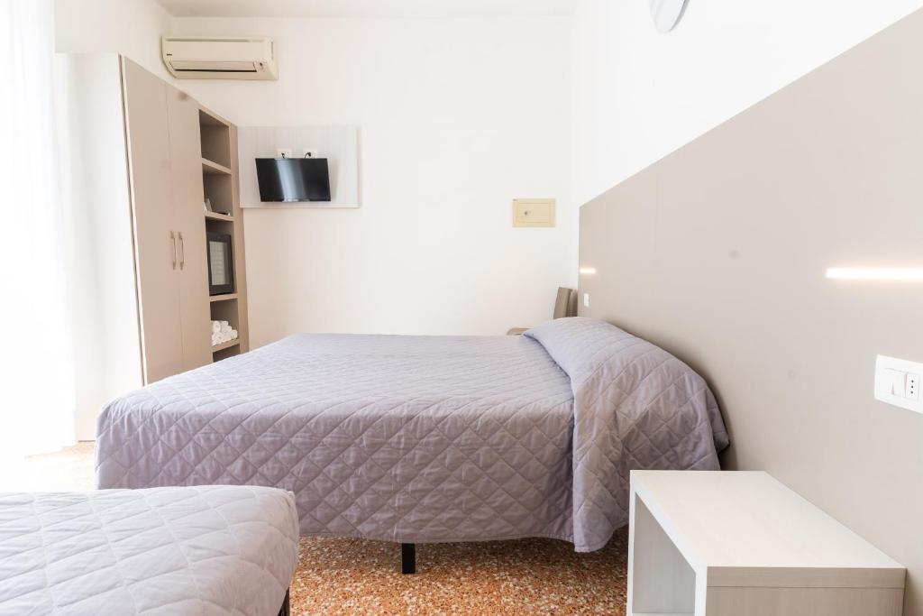 Postel nebo postele na pokoji v ubytování Hotel Ischia
