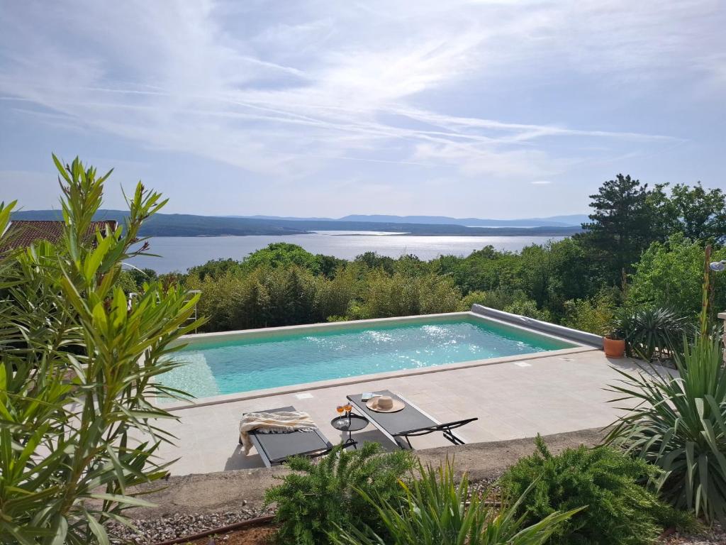 a swimming pool with a view of the water at Villa Belvedere in Crikvenica