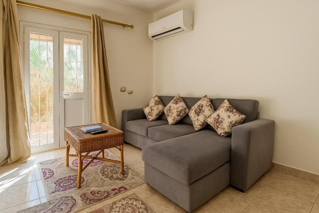 a living room with a couch and a table at 1038 · 2BR TownhouseBath TV Backyard in Sheikh Zayed