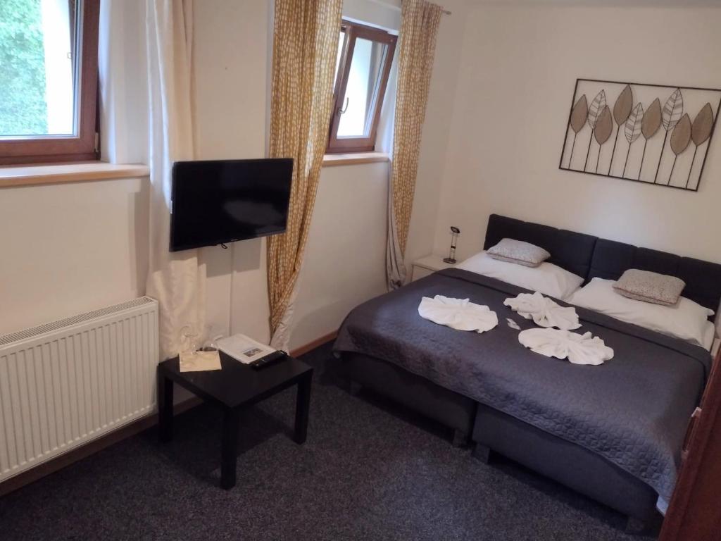Postel nebo postele na pokoji v ubytování Hotel PODKOST