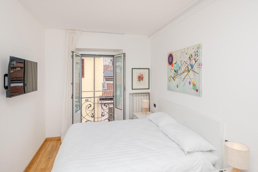 Una habitación blanca con una cama y una ventana en Casa SiLinda by Comorooms, en Como