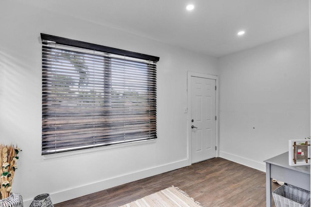 a white room with a window and a door at Splendid Mediterranean Retreat Gorgeous Outdoor in North Miami