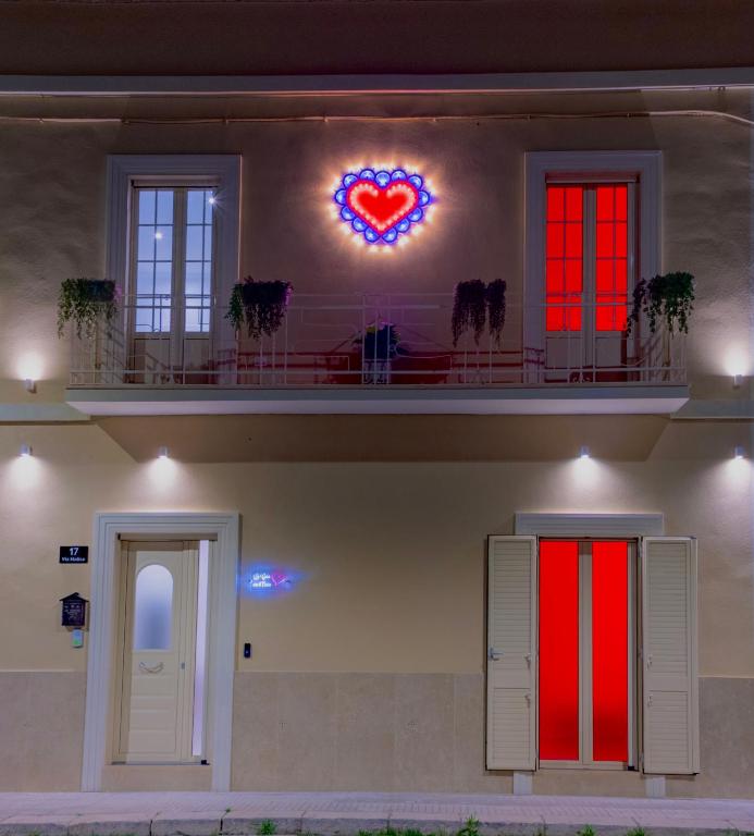 a house with a heart sign on the wall at La Casa con il Cuore in Brindisi