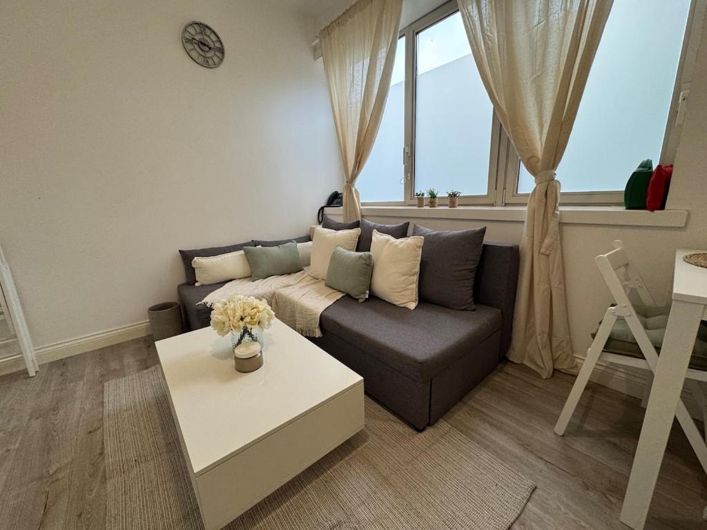 a living room with a couch and a table at 29 Sweet 1 Bed sleeps 4 with free parking BHX NEC in Sheldon