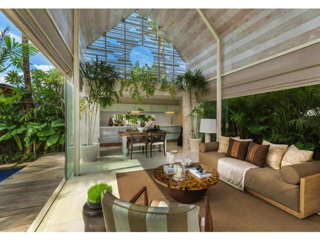 a living room with a couch and a table at Kawung Villa Canggu in Canggu