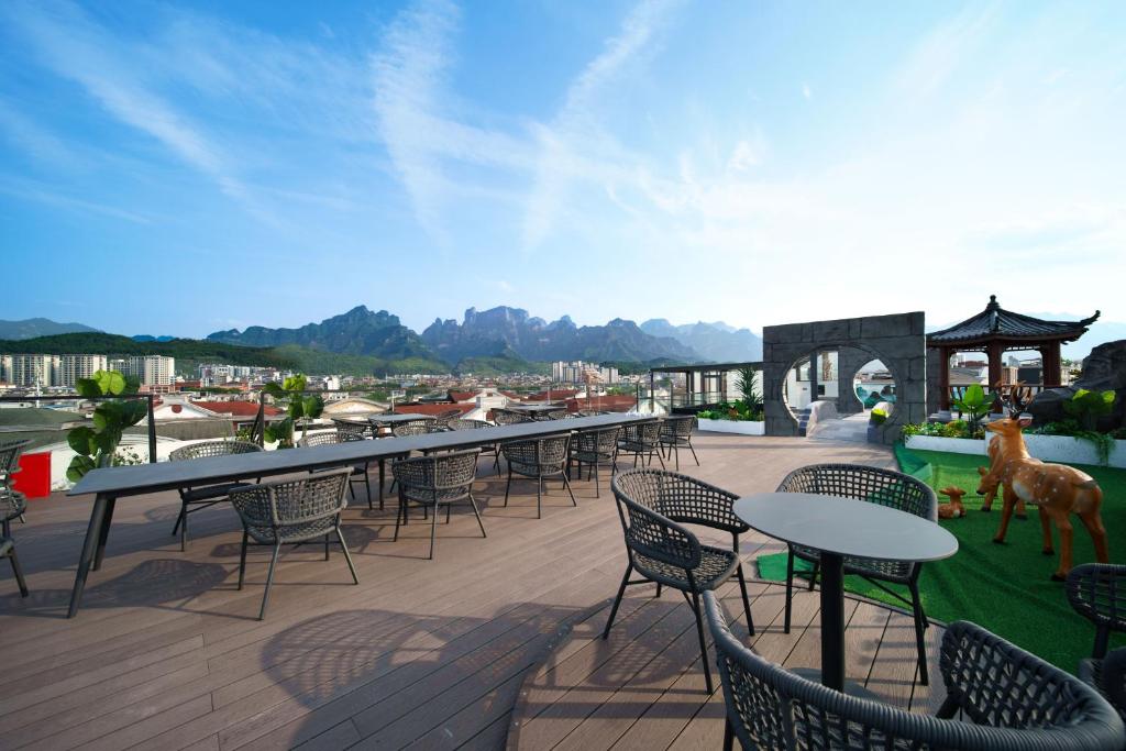 a group of tables and chairs on a patio at Zhangjiajie Tianmenshan Xuyuan Hotel in Zhangjiajie