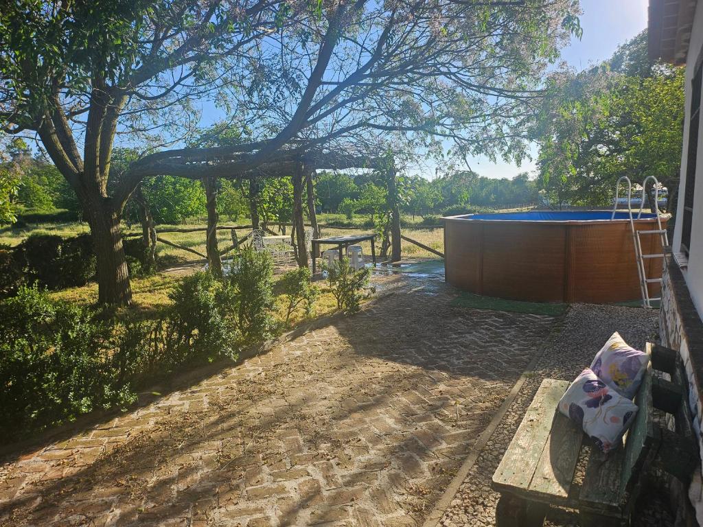 a backyard with a hot tub and a tree at Casa Las Vacas, Aracena in Aracena