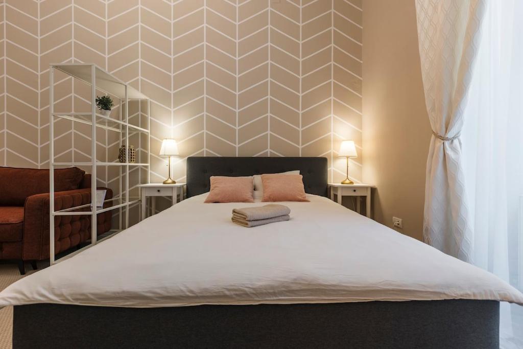a bedroom with a bed with two pillows on it at #Comfy Apartment in Old Town in Timişoara