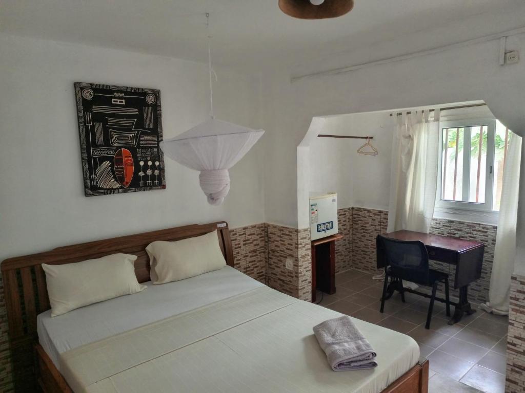 Postel nebo postele na pokoji v ubytování Casa Cacheu Homestay Guest House
