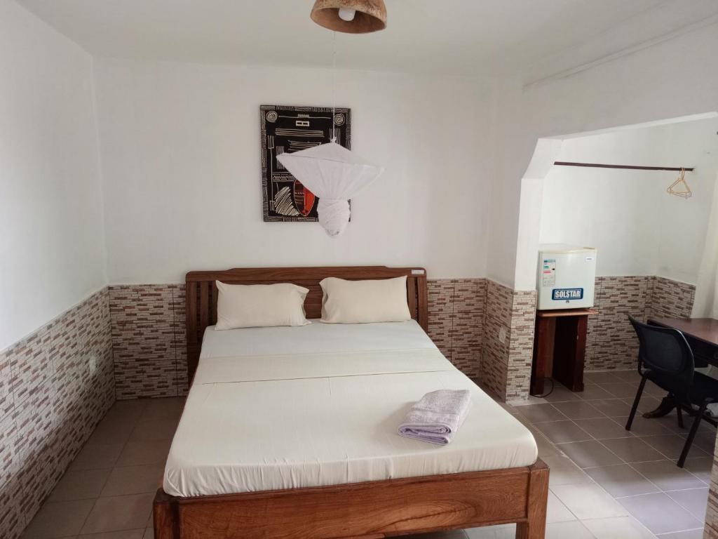 Postel nebo postele na pokoji v ubytování Casa Cacheu Homestay Guest House