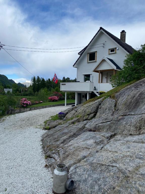a house sitting on top of a rocky hill at Peaceful Riverfront Home with Views in Ålgård
