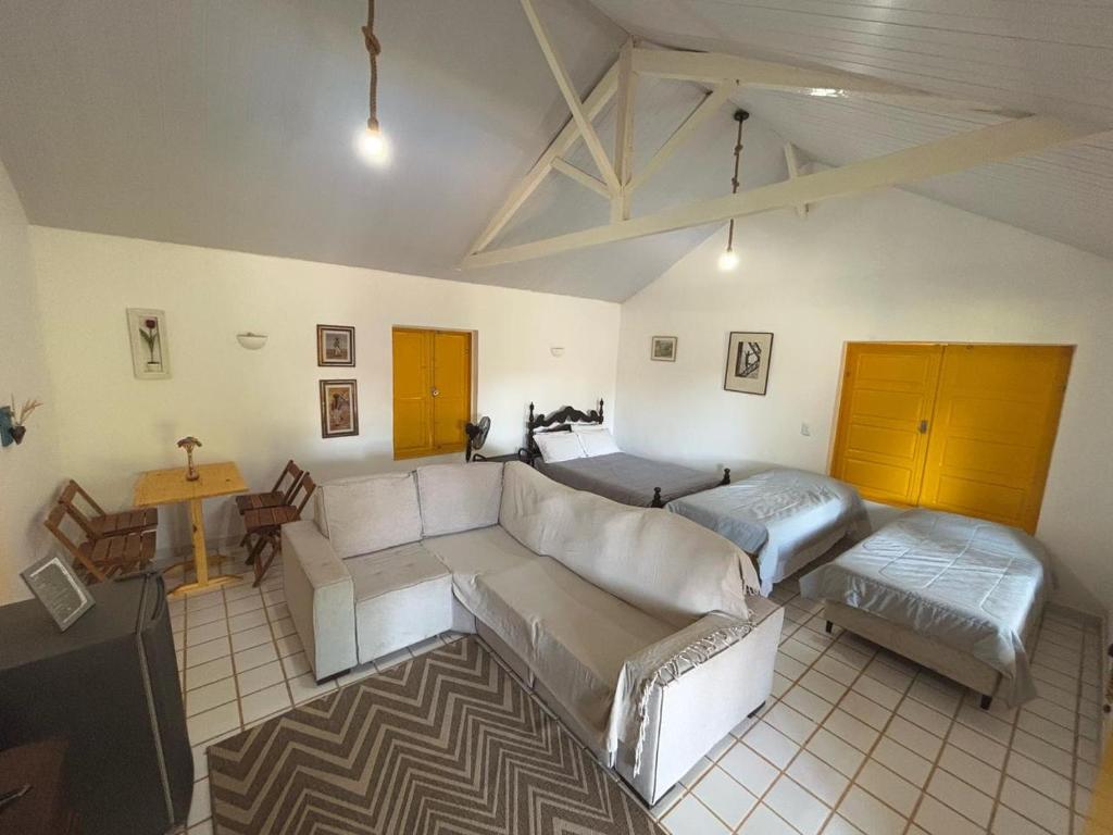 a living room with a couch and a table at Loft Cerejeira no Sítio Gaia Miguel Pereira RJ in Miguel Pereira