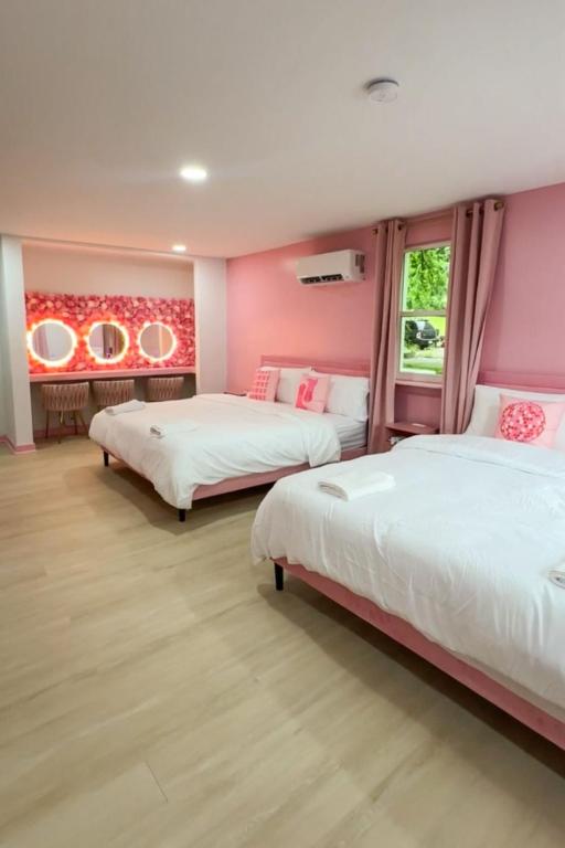 two beds in a room with pink walls at Pink Nashville Cottage - Girls' Trip, 12 Min to Broadway in Nashville