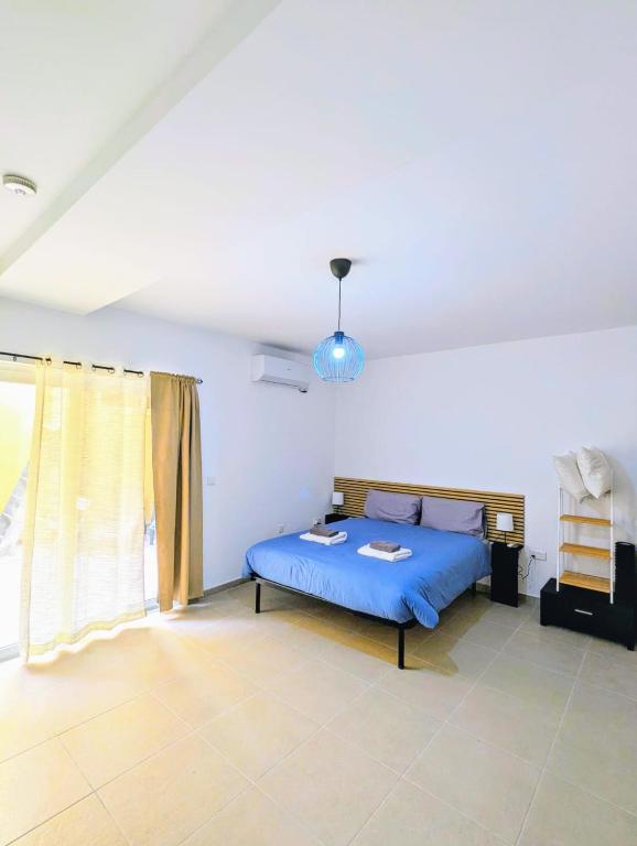 Postel nebo postele na pokoji v ubytování Gozo Vacation Studios
