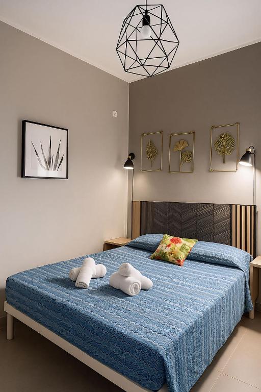 A bed or beds in a room at VISTA MARE Gallipoli Perla Marina