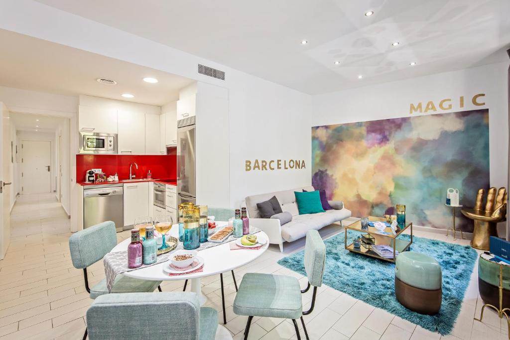 a kitchen and a living room with a table and chairs at Sweet Inn - Sants in Barcelona