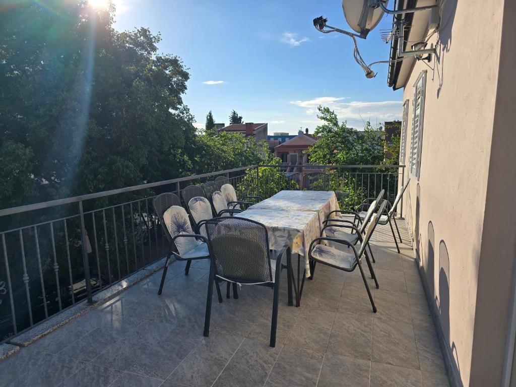 a table and chairs on the balcony of a building at Apartment Tome in Biograd na Moru