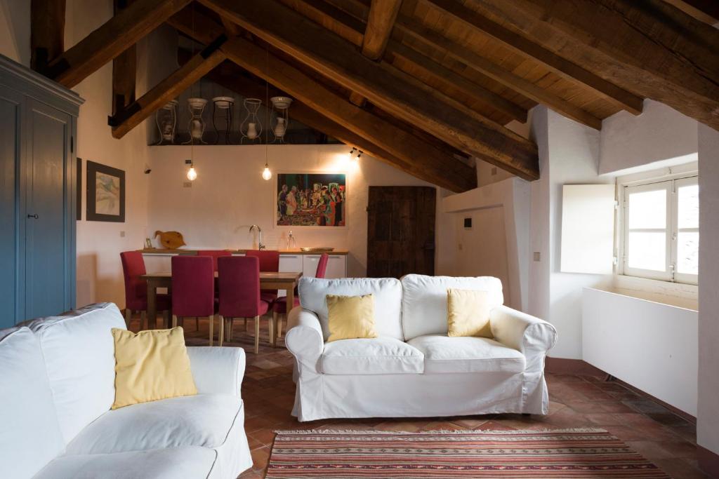 a living room with a white couch and a table at Castello di Rocca Grimalda in Rocca Grimalda