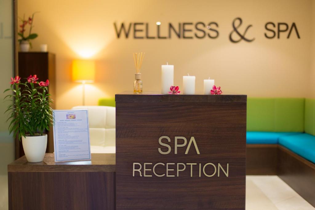 a sign for a wellness and spa reception in a hotel room at Blue Waves Resort in Malinska