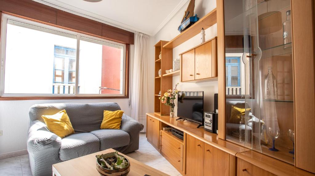 a living room with a couch and a tv at Casa Marinera en A Guarda in A Guarda