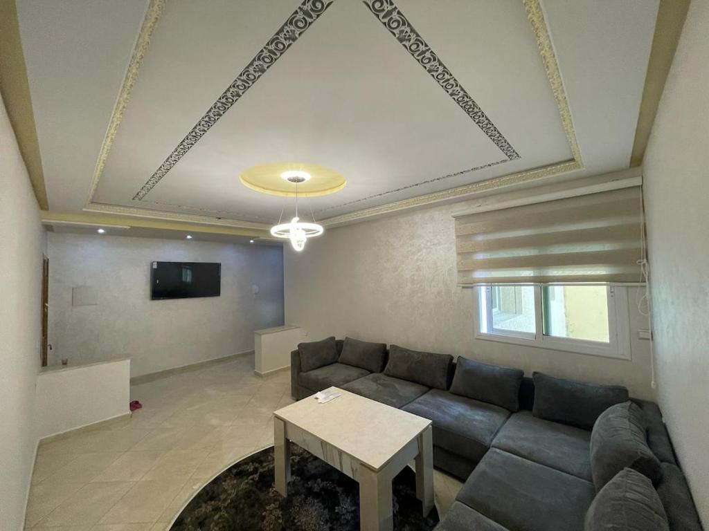 a living room with a couch and a table at Appartement royal à tanger in Tangier