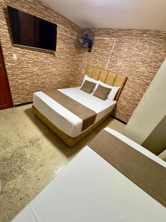Postel nebo postele na pokoji v ubytování Hotel Pereira Central
