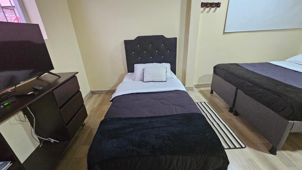 Postel nebo postele na pokoji v ubytování Roma House N- suite Campin Movistar Ministerios Simón Bolivar