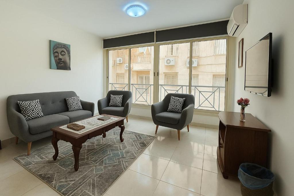 a living room with a couch and two chairs and a table at 2 BR entire apartment - 1402 in Sheikh Zayed