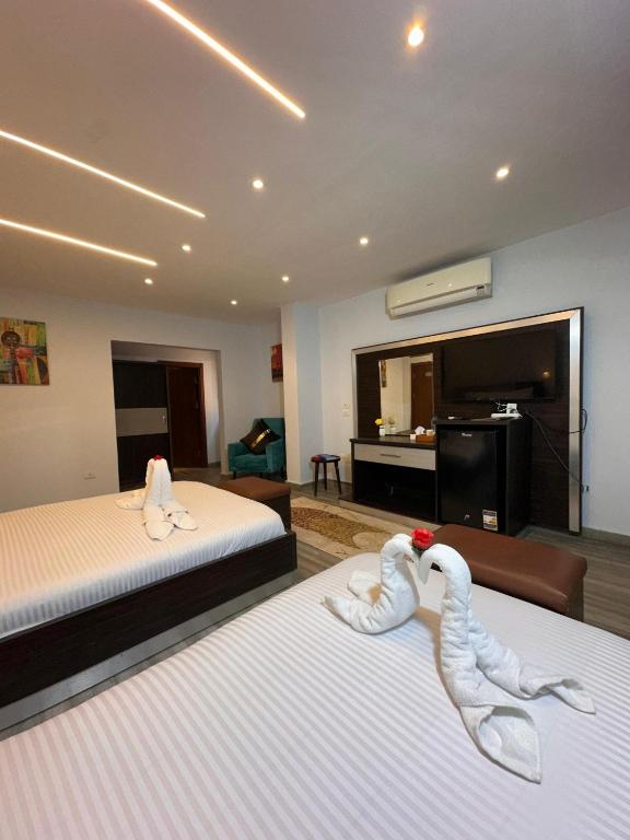 Postel nebo postele na pokoji v ubytování Kayan Pyramids Hotel