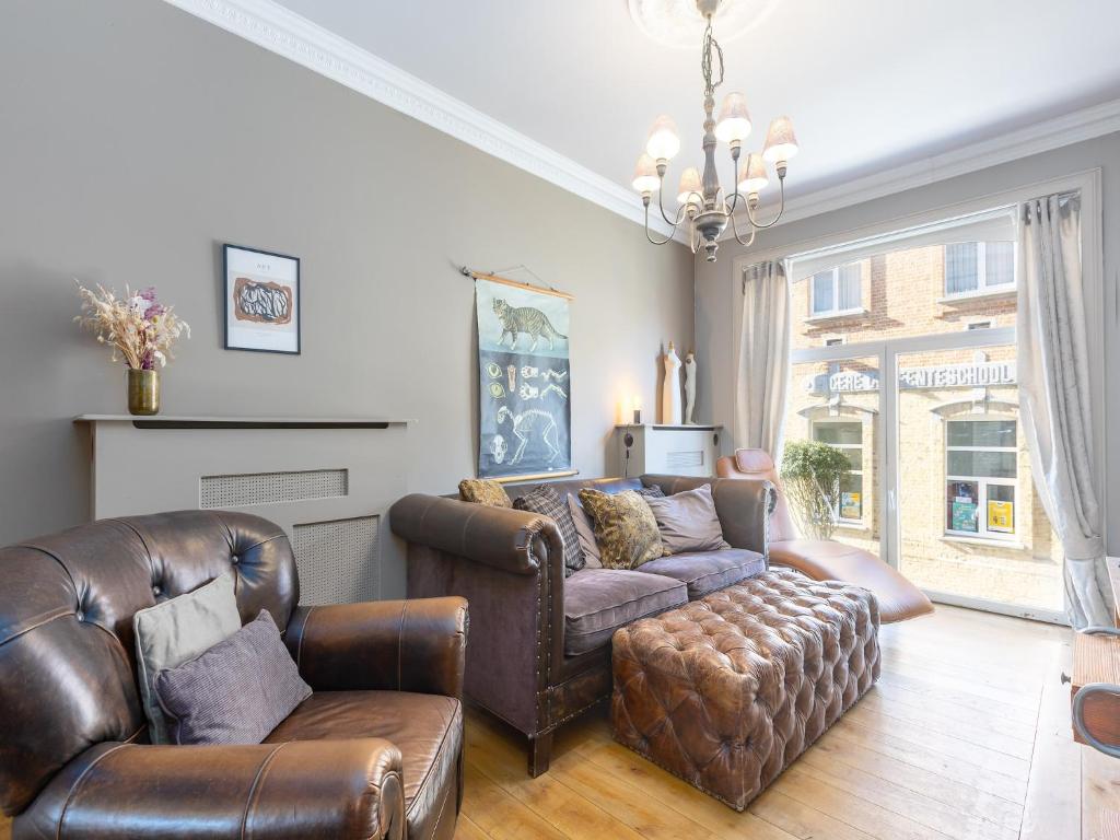 a living room with leather furniture and a couch at Holiday home for 6 people with garden in Middelkerke